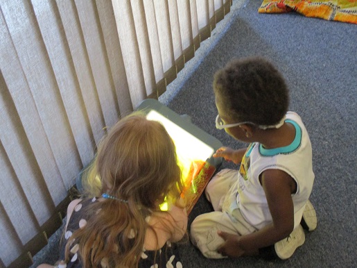 Two children playing with the light display at Make it Take it